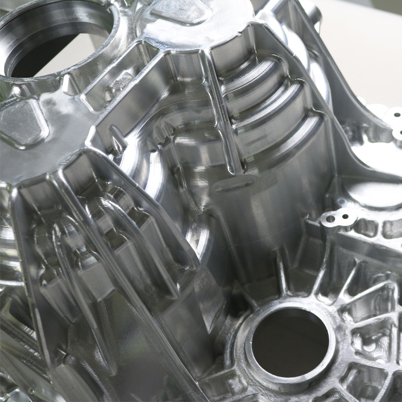 Close-up of CNC machined aluminum pockets, curved surfaces and bore features