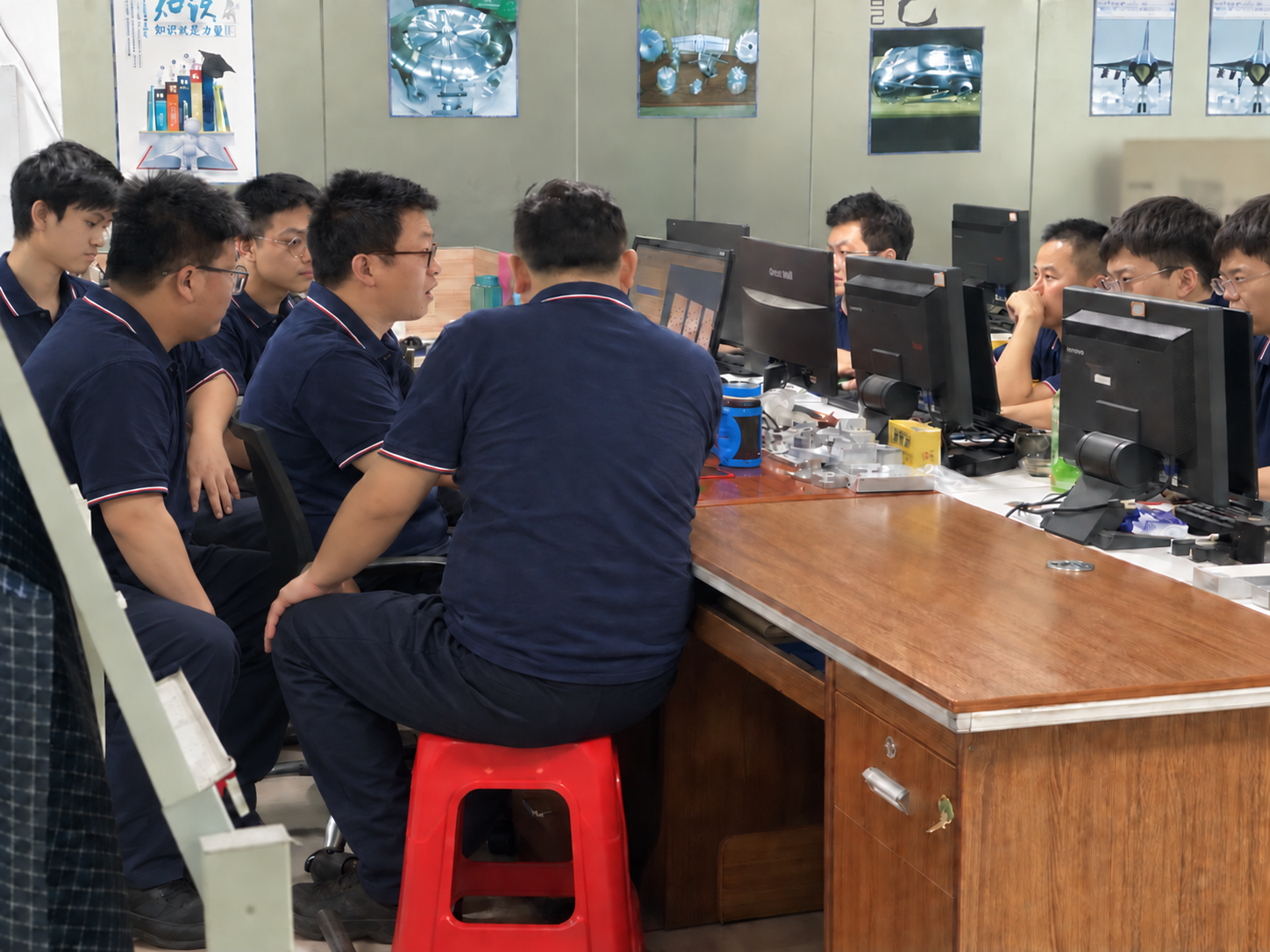 Engineering team reviewing project drawings and CAD